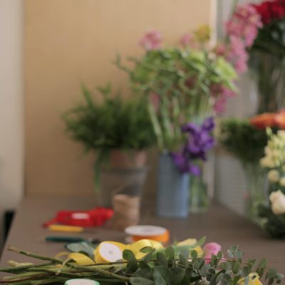 Side view of uncompleted bouquet with yellow roses on counter in flower shop