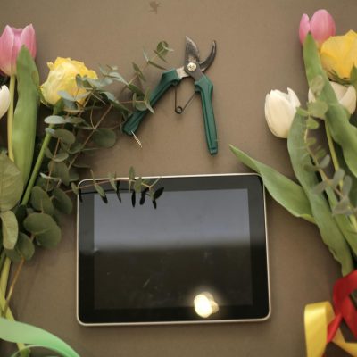 Tablet and flower bunches on floral shop counter